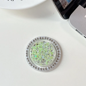 Detail of round phone grip holder with green glitter sequins and sparkling rhinestones