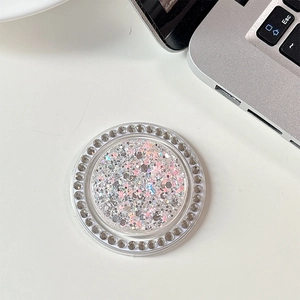 Macro shot of round crystal phone grip with pink sequins and star glitter detail