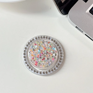 Macro shot of circular phone grip with colorful sequins and white rhinestone border decoration