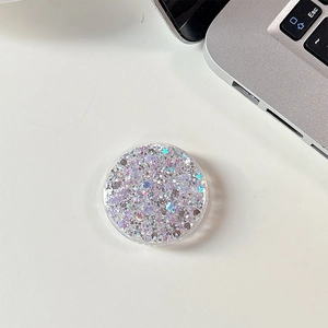 Macro detail of round phone socket holder with pink holographic glitter and sequins