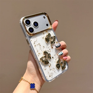 Dettaglio custodia iPhone trasparente con inserti in foglia d'oro e fiocchi 3D oro