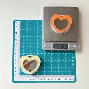 Macro view of heart-shaped mirror phone sockets in orange and cream yellow colors