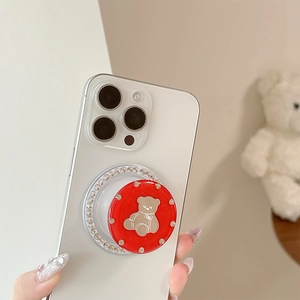 Detail view of red pop-up phone socket with rhinestone trim and cartoon bear design