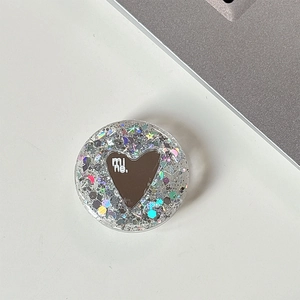 Close-up of a round glitter phone socket with a heart mirror and 'mine.' text detail