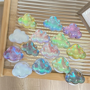 Iridescent laser cloud-shaped phone socket grip displayed on decorative glass tray