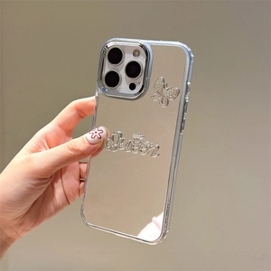 Close-up of mirror phone case with rhinestone Queen crown and butterfly design