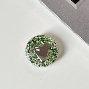 Green glitter phone socket with heart mirror and mine lettering on white desk