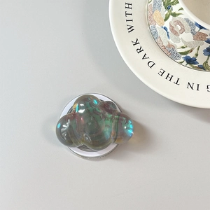 Macro detail of cloud-shaped laser iridescent phone socket with metallic aurora finish