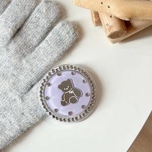 Detail of lavender bear phone grip with sparkling rhinestones on a rustic background