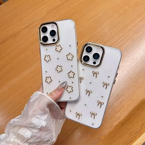 Detail of glitter iPhone case with floral bow accents and gold plating on lens frame