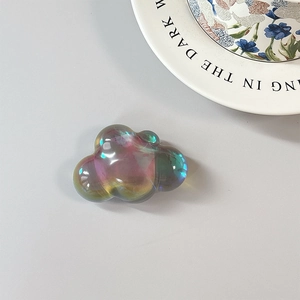 Macro detail of cloud-shaped laser iridescent MagSafe phone socket with holographic finish