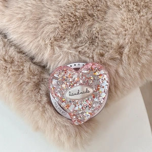 Macro shot of heart-shaped pink glitter phone grip with handmade and Gift For You text