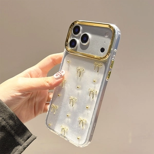 Close-up of clear iPhone 14 Pro Max case with gold glitter bows and electroplated frame