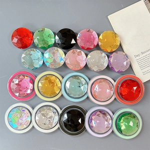 Macro view of colorful faceted rhinestone phone grip bases in vibrant dopamine colors