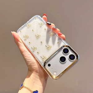 Detail of transparent iPhone case with gold 3D bows and sparkling glitter inlay