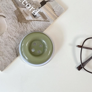 Close-up of candy color button phone socket with dark green glossy resin finish