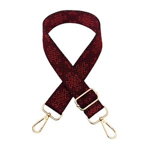 Adjustable wide guitar style strap with red and black geometric pattern and gold hooks