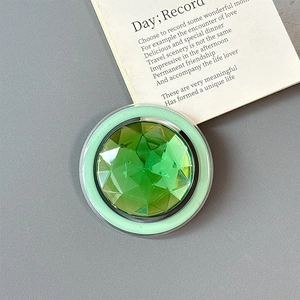 Macro shot of emerald green gemstone phone socket holder with a luxury faceted design