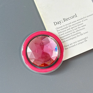 Macro shot of a round phone socket featuring a faceted pink crystal gemstone with sparkles