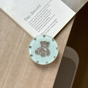Detail of light green resin phone socket with silver rhinestones and brown bear design