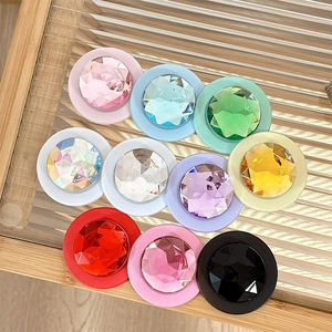 Macro detail of various colorful crystal gemstone grips on a striped glass tray