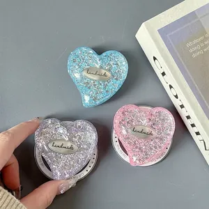 Glitter heart phone grip set in blue, purple, and pink with handmade metal tag