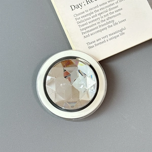 Top view of a round magnetic phone grip with large faceted crystal and dual-tone frame
