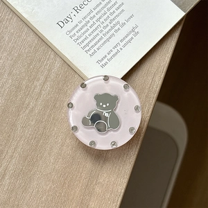 Close-up of pink round phone grip featuring a silver mirror bear with rhinestone border