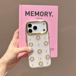 Close-up of golden floral pattern and glitter detail on clear iPhone case held by hand
