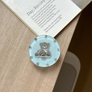 Detail of light blue round phone grip with silver bear mirror and rhinestone border