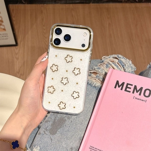 Close-up of white flower pattern phone case for iPhone with gold trim in a lifestyle setting