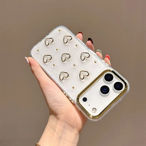 Detail of glitter iPhone case with 3D gold heart patterns and camera lens protection frame
