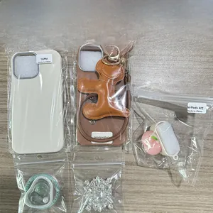 Detail shot of iPhone 16 Pro Max cases and AirPods 4 accessories on wood background