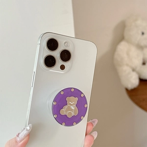 Cute purple phone grip with brown bear and rhinestones mounted on white mobile phone