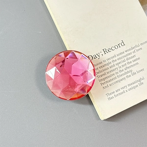 Macro view of a pink faceted geometric resin grip for luxury smartphone decoration