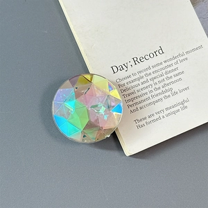 Macro detail of aurora crystal phone grip featuring multifaceted iridescent rhinestone surface