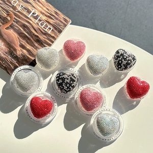Detailed view of heart-shaped rhinestone phone grips in various vibrant colors
