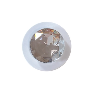 Minimalist white phone socket grip featuring a large faceted diamond-like crystal top