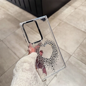 Detail of silver heart-shaped rhinestones and metallic camera frame on transparent phone case