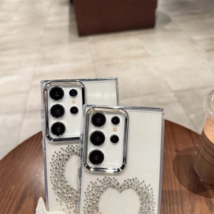 Close-up of heart-shaped rhinestone phone case with silver plated camera bezel detail