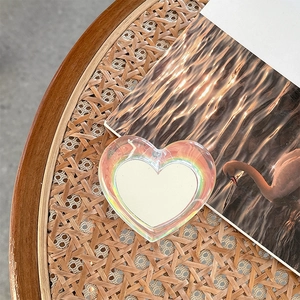 Macro shot of laser-hearted phone grip on a vintage wicker tray with swan art decor