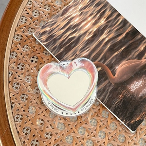 Detailed view of a laser heart phone grip with Gift For You print on a warm aesthetic book