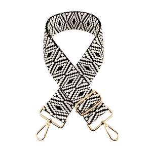 Close-up of black and white geometric pattern woven strap with gold metal lobster clasps