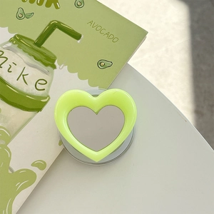 Detail of heart-shaped magnetic phone grip with vanity mirror in lime green