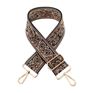Close-up of black Paisley embroidered bag strap with golden metal lobster clasps and buckle