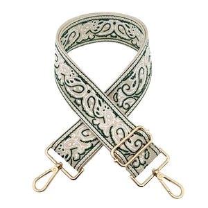 Detail of adjustable paisley embroidery bag strap with gold metal lobster clasps