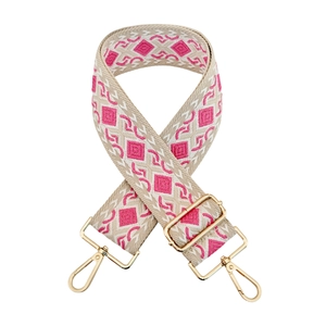 Detail of pink diamond jacquard wide bag strap with glossy gold metal lobster clasps