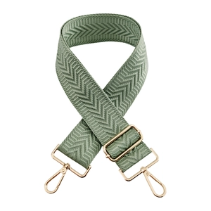 Detail of sage green 5cm wide crossbody bag strap with chevron weave and gold hooks