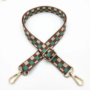 Adjustable checkerboard crossbody bag strap with gold metal hooks and buckle on white background