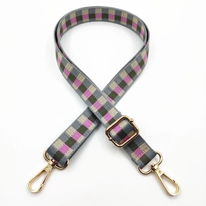 Detail of adjustable checkered bag strap with gold swivel hooks in multi-color weave